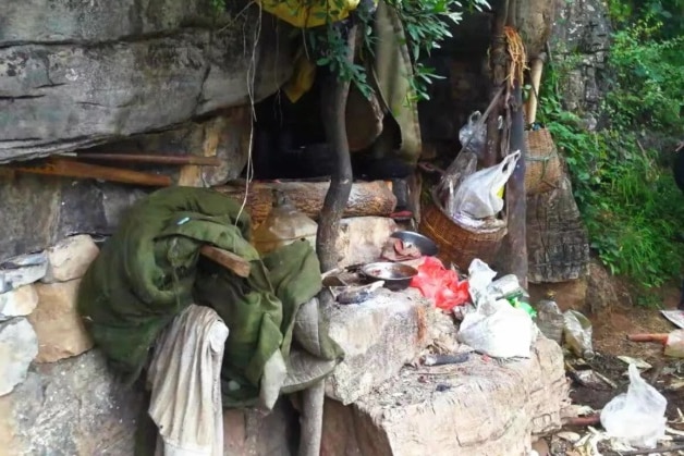 Rubbish and other trinkets outside the entrance to the cave.