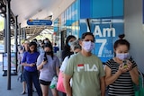 A long queue forms outside a chemist in Darwin.