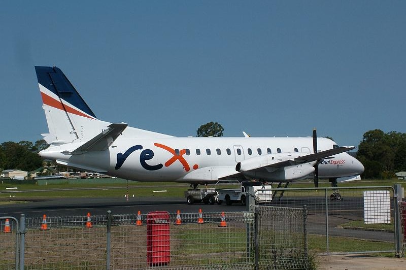 A Rex airplane on a tarmac