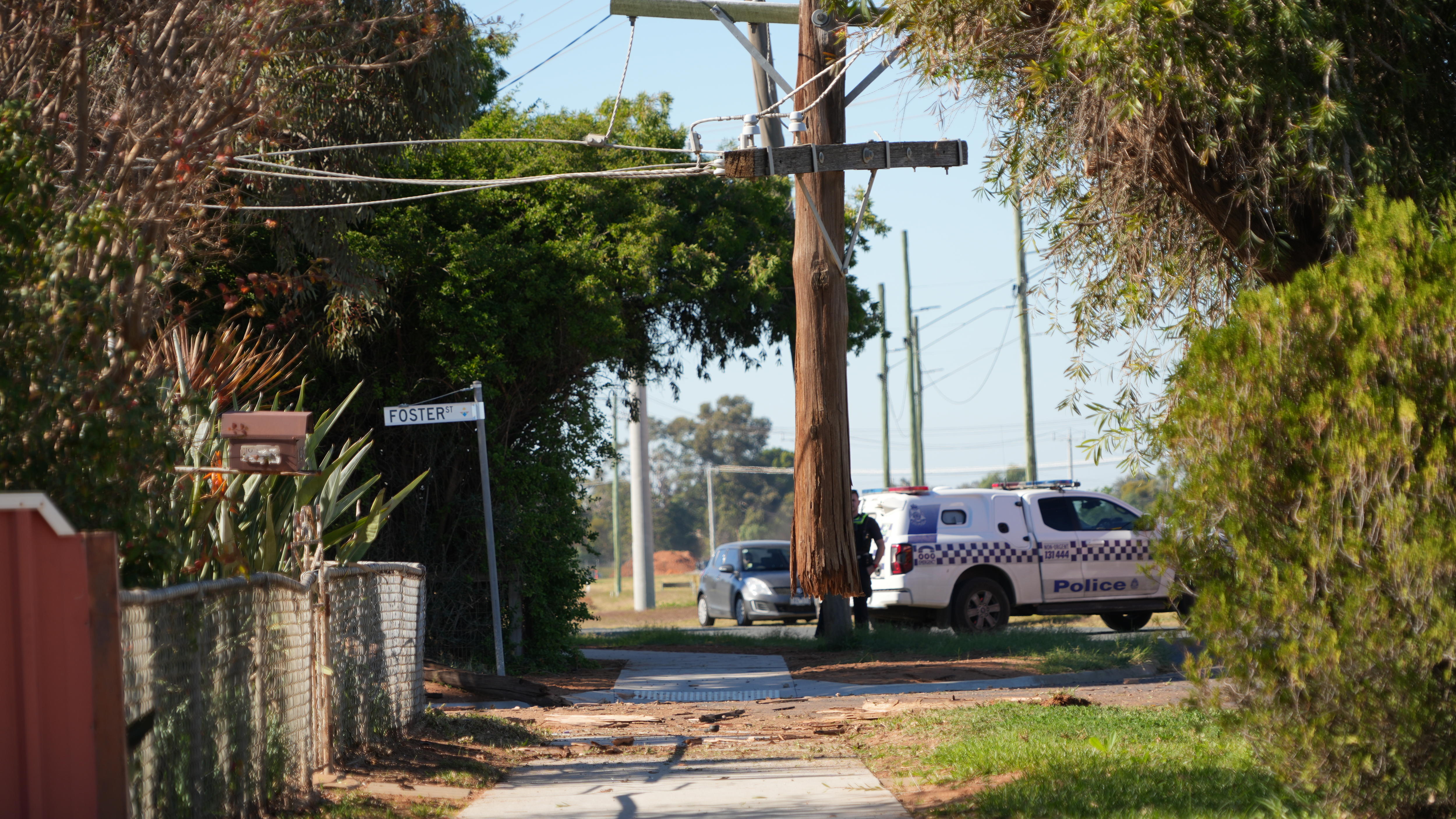 A wooden power pole, with the bottom quarter missing