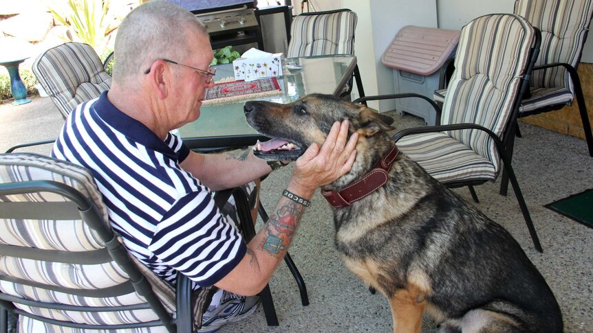 Turk is embraced by his former handler, Corporal Bruce Ross.