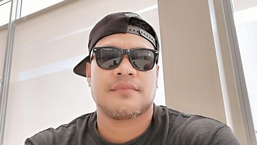 Young-looking pacific islander man wearing black shirt and sunglasses.