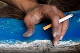 Indigenous hand holding cigarette