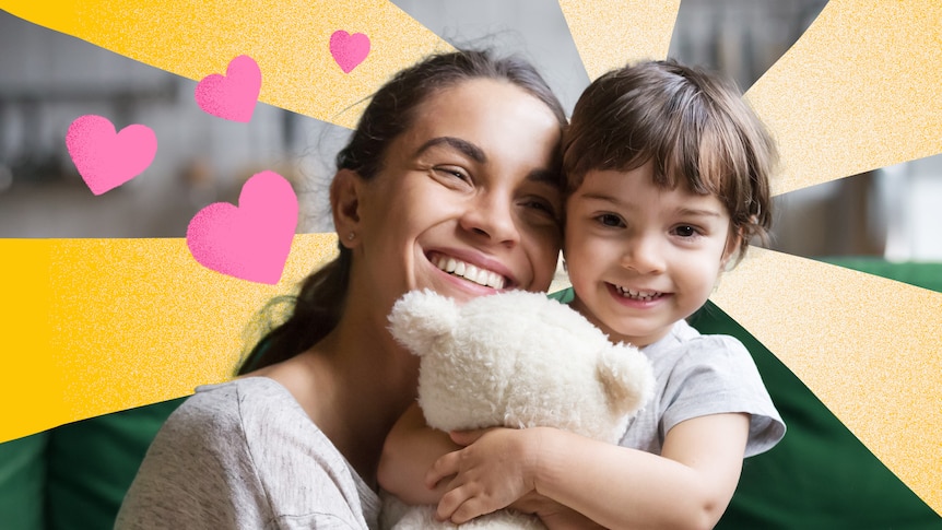 Woman grins as she cuddles a cute young child. Love hearts and sunbeams surround them