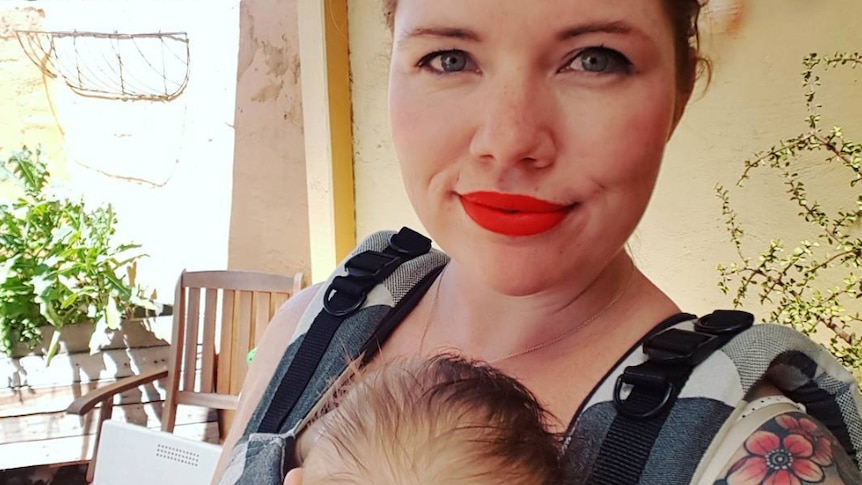 Clementine Ford holds her baby on her chest.