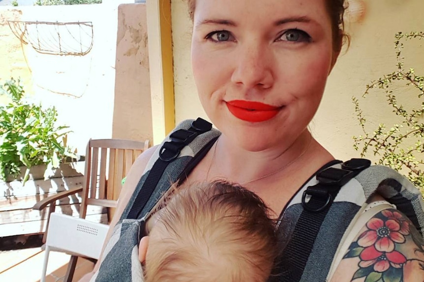Clementine Ford holds her baby on her chest.