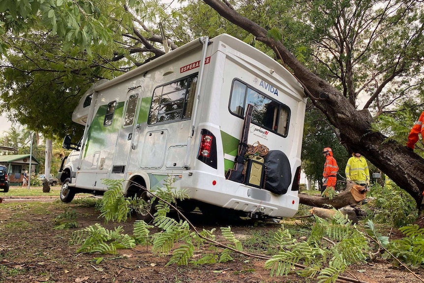An RV with tree branch fallen on roof.