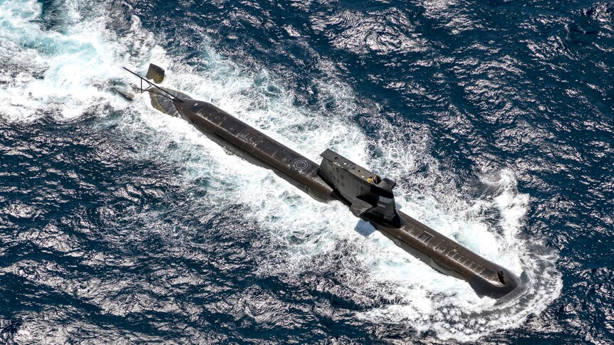 aerial shot of the top of a sub in sparkling deep blue water
