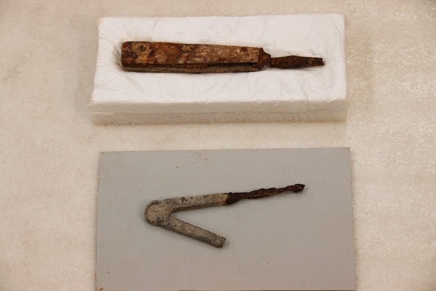 A bone handled tool and a compass from the Port Arthur dig.