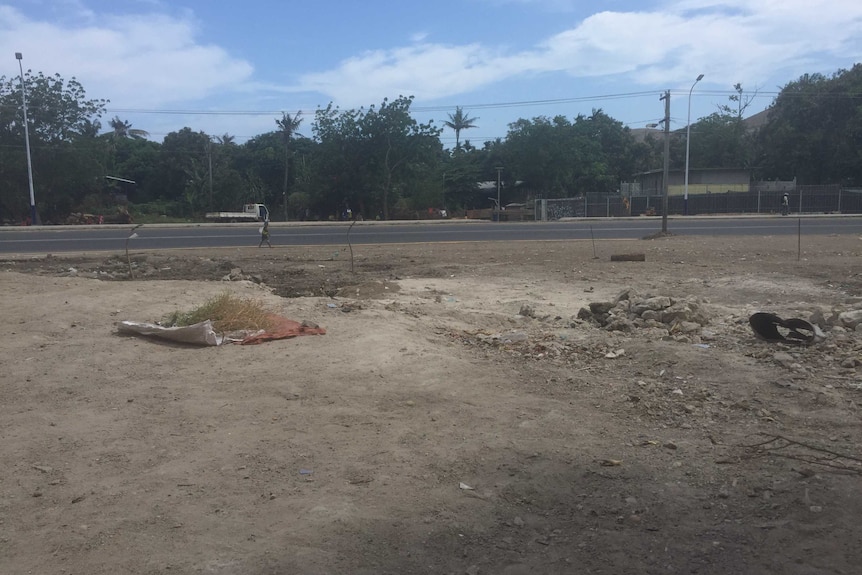 a dirt patch next to a road