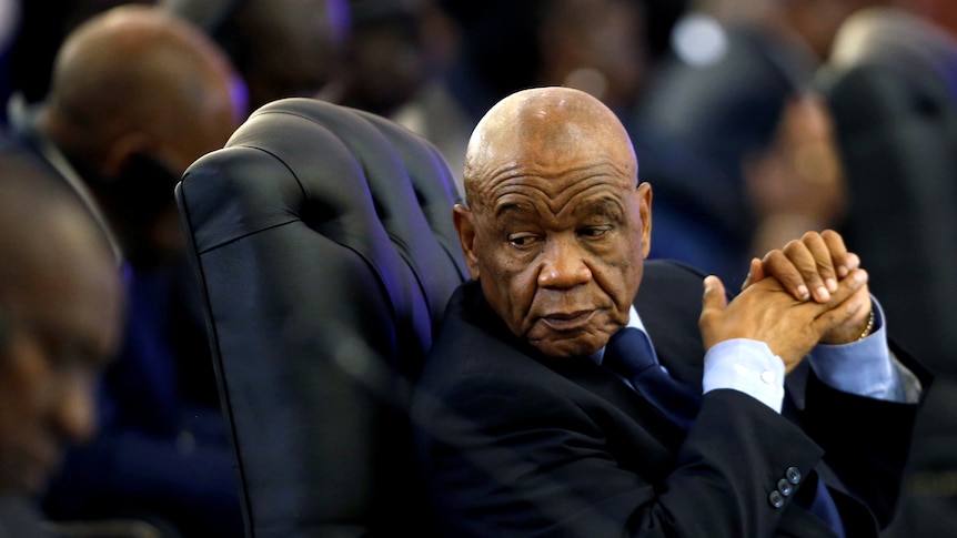 Former PM of Lesotho Thomas Thabane sits in a chair at a summit in South Africa, in 2017.