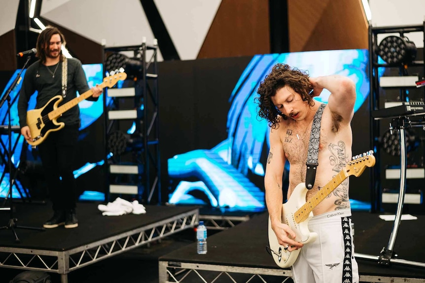 A shot of Reuben and a shirtless Adam rehearsing for Splendour In The Grass