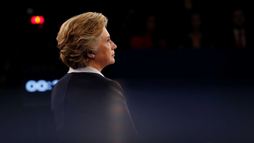 Democratic U.S. presidential nominee Hillary Clinton listens as Republican U.S. presidential nominee Donald Trump (not pictured) speaks during their presidential town hall debate