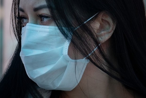 Unidentified female wearing a respiratory mask.