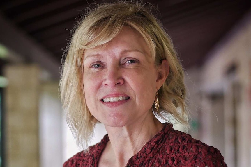 A headshot of Sandra Hesterman in a red top.