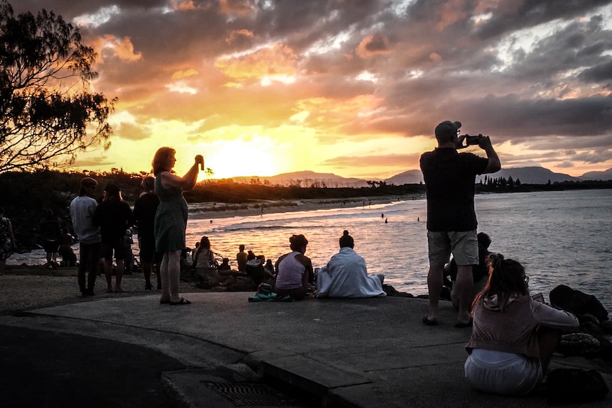 Amateur photographers snap up a beautiful Byron Bay sunset.