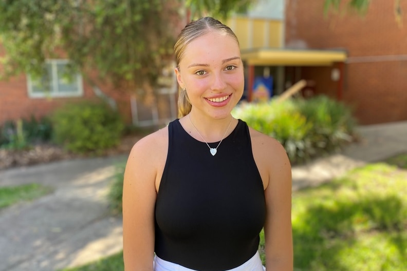 A university student smiling at the Charles Sturt University campus in Wagga Wagga