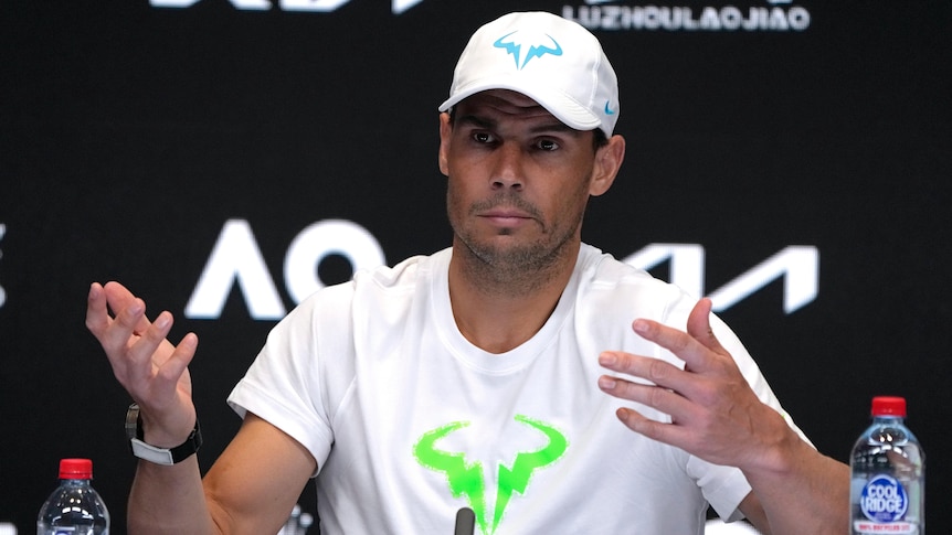 Tennis player Rafael Nadal shrugs while sitting in a press conference at the Australian Open.