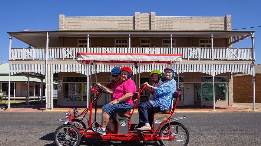 a bike rides past a historic outback Queensland building in Charleville