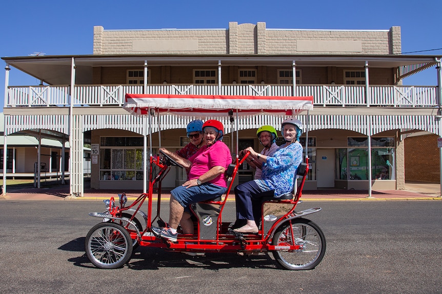 a bike rides past a historic outback Queensland building in Charleville