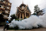 A city worker fumigates the area to control the spread of mosquitoes at a temple in Bangkok, Thailand, September 14, 2016.