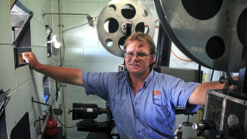 Steve Snell with two old film projectors