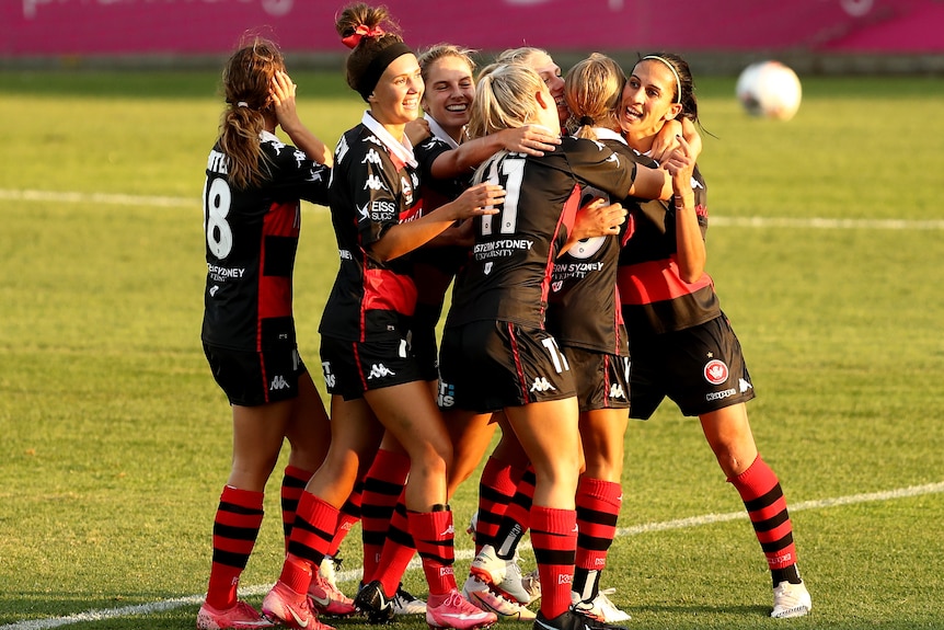 Western Sydney Wanderers hug.