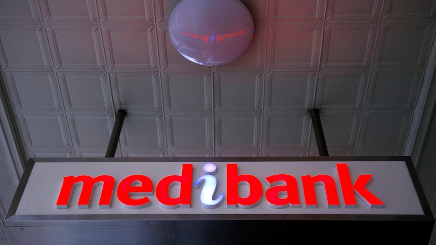 An illuminated sign is seen outside a branch of the Australian health insurer Medibank Private in Sydney.