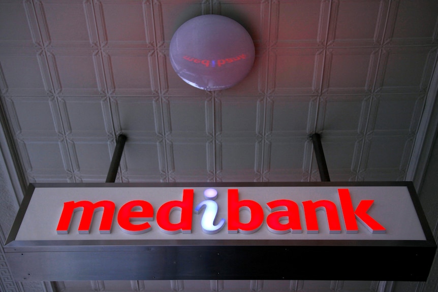 An illuminated sign is seen outside a branch of the Australian health insurer Medibank Private in Sydney.