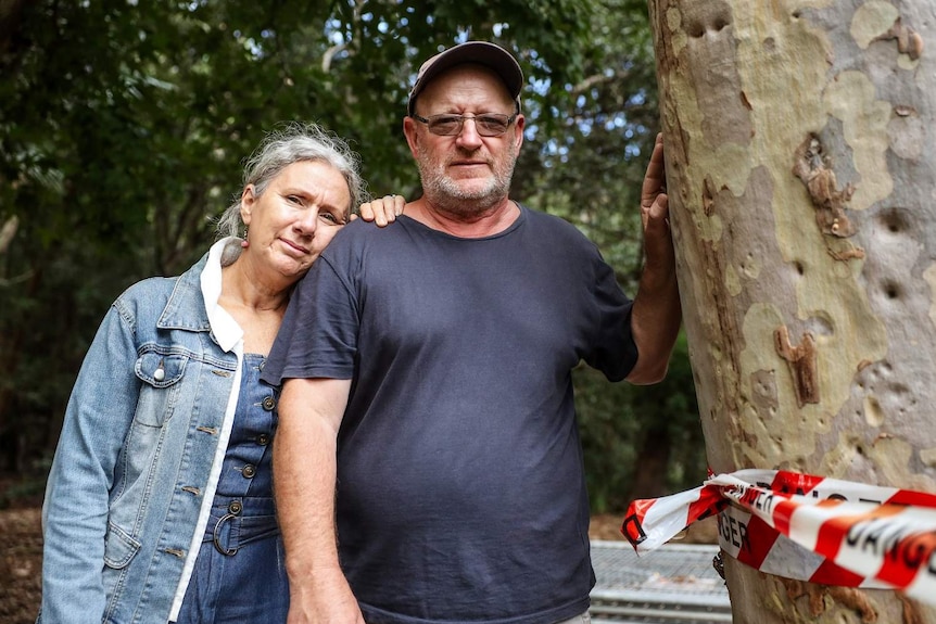 A man and woman, Ray and Lorraine Kemp, look at the camera with slightly sad expressions