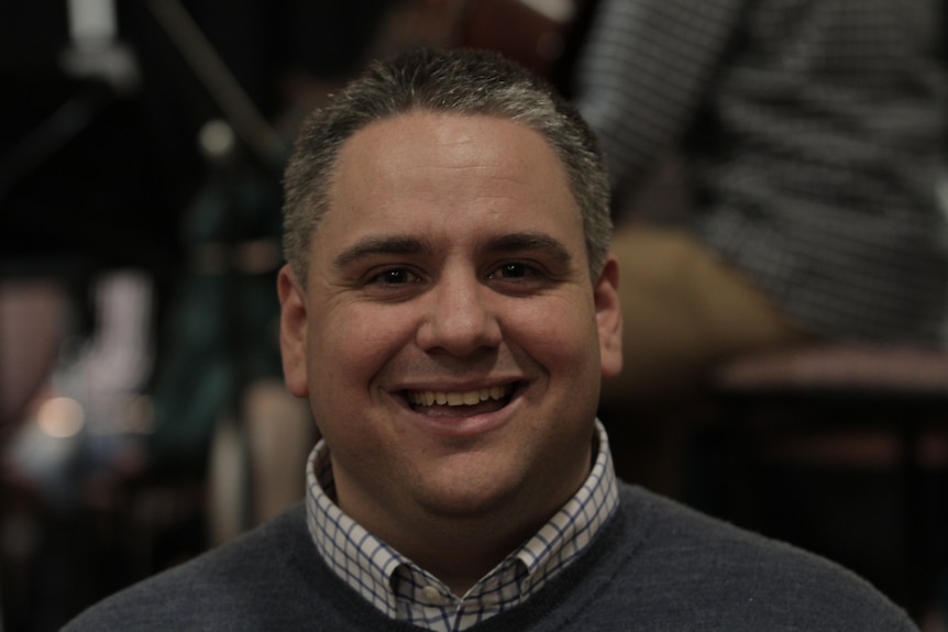 Head shot of Western Sydney Youth Orchestra conductor James Pensini looking at the camera