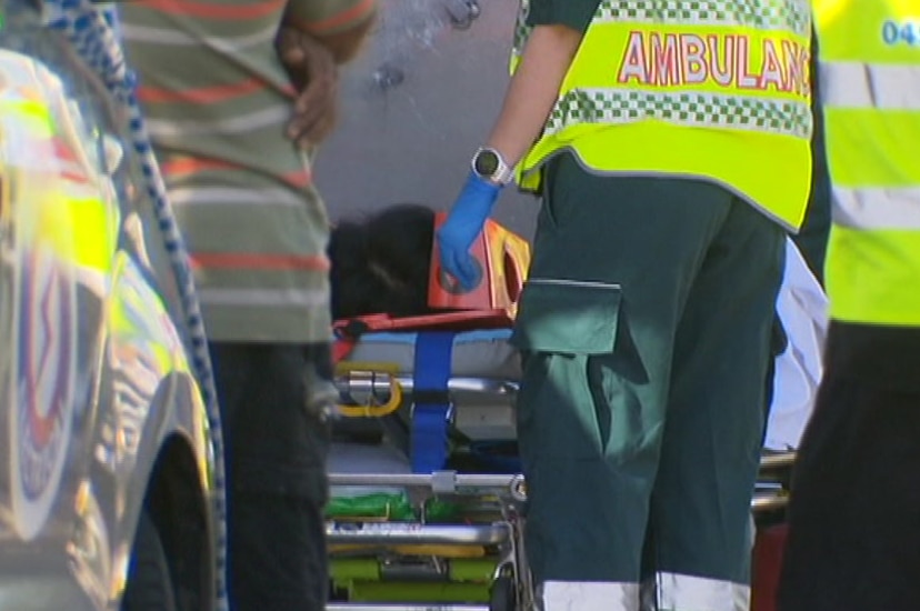 Emergency crews around a person on an ambulance stretcher.