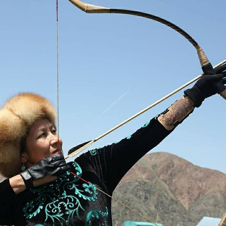 woman holds arrow.