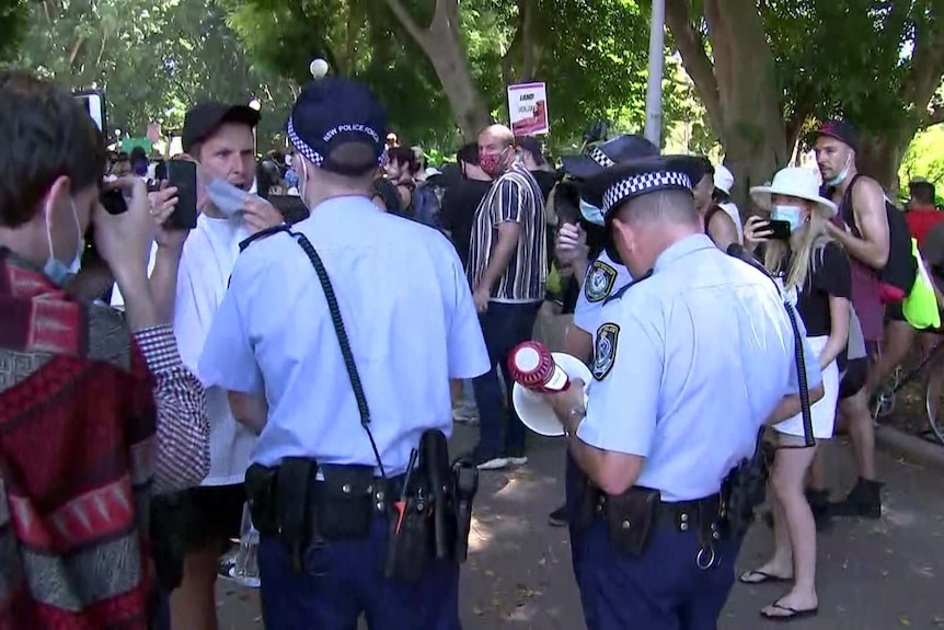 Two police in a verbal altercation with a protester