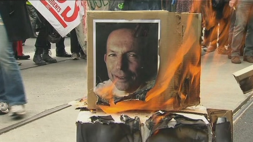 Students burn an effigy of Tony Abbott as they protest against university fees