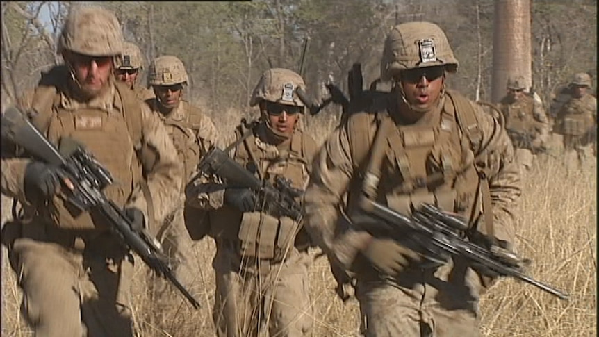 US Marines run through the scrub at Bradshaw Training Area