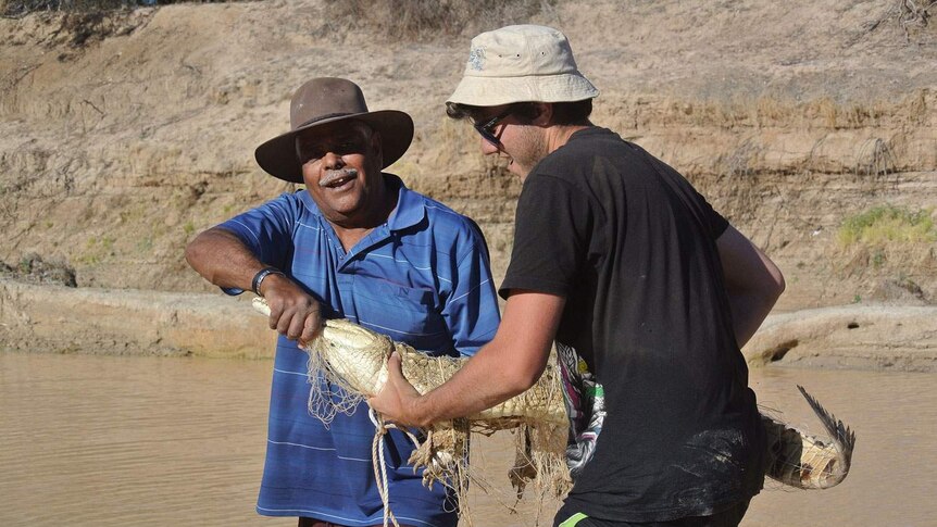 (LtoR) senior Queensland Parks and Wildlife ranger Don Rowlands and volunteer croc catcher James Brough with the croc