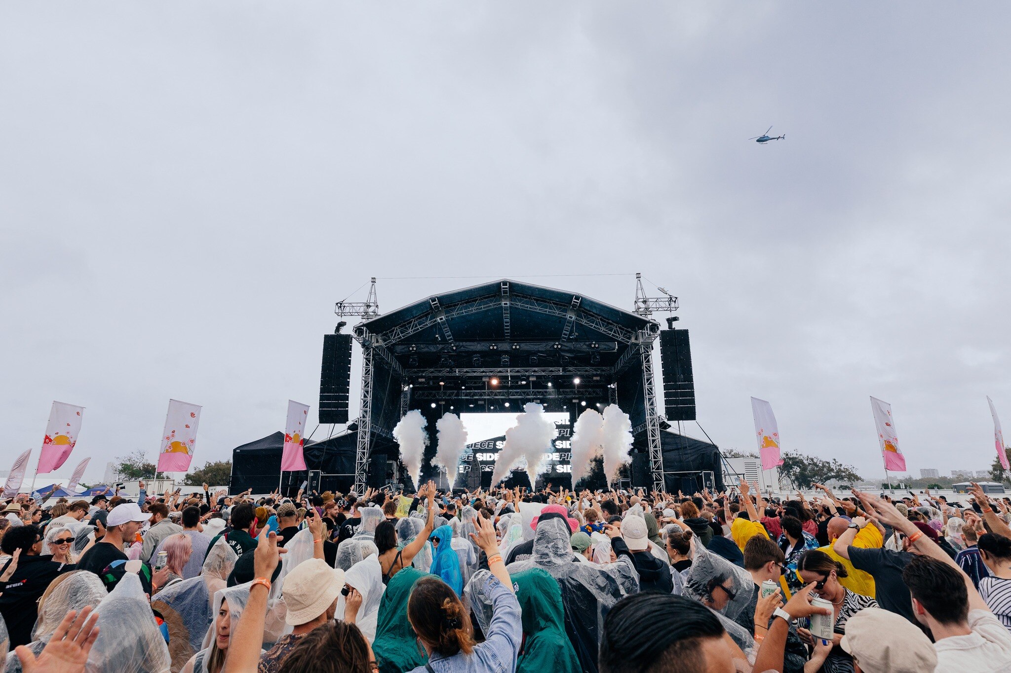 Hundreds of people at a festival in front of stage
