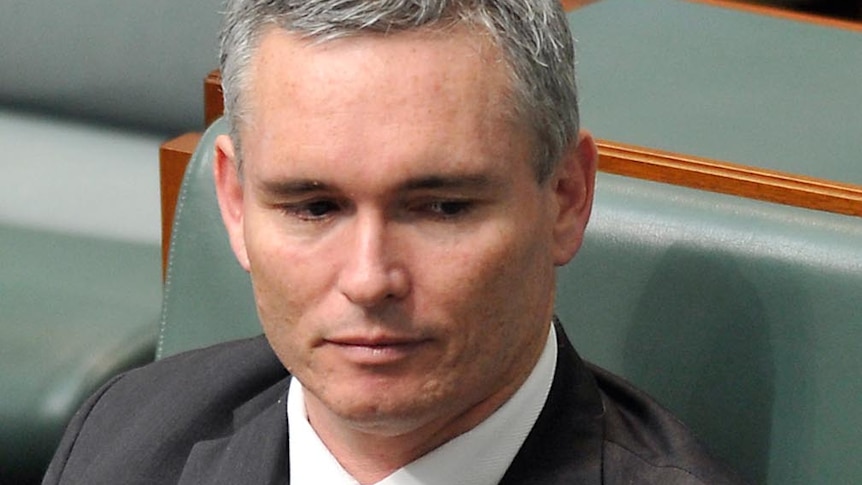 Craig Thomson listens during question time