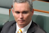 Craig Thomson listens during question time
