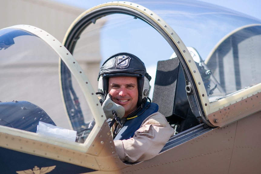 Pilot sitting in the cockpit of a small plane. 