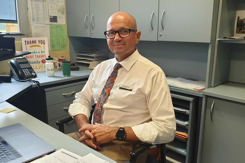 Orara High School Principal Malcolm McFarlane sitting at his desk