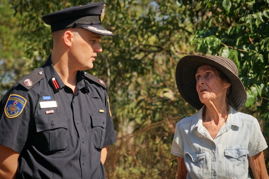 Rural resident Nancy Nathanael and fire officer Joshua Fischer speak outside at Nancy's rural property.