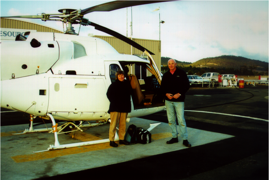 Willemina and John Watts standing next to the supplies helicopter for Maatsuyker Island, 1 May 2000.