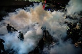 Turkish anti riot police officers launch water cannon and tear gas to disperse supporters of the Turkish Zaman Daily newspaper