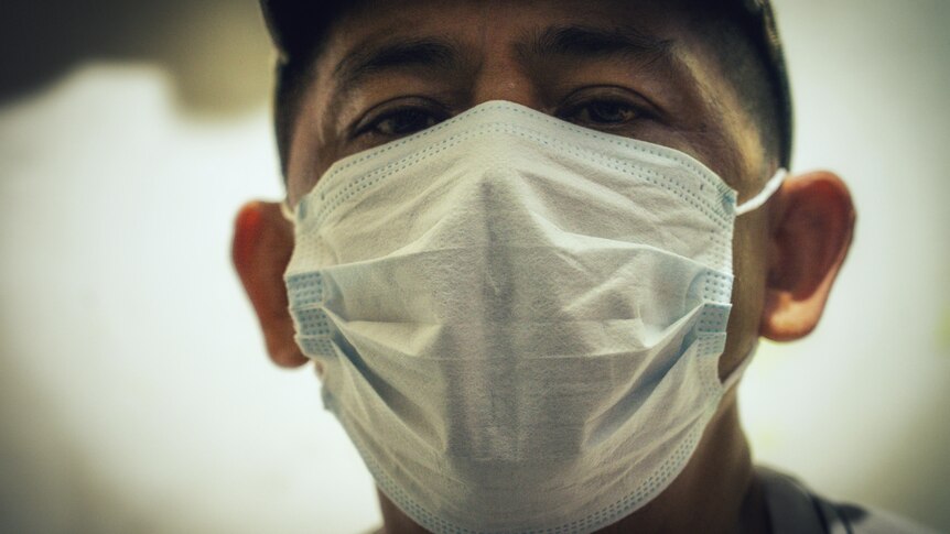 A Filipino man in a white face mask 