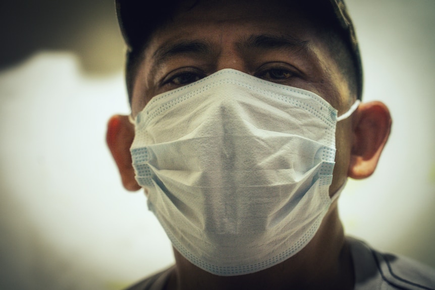 A Filipino man in a white face mask 