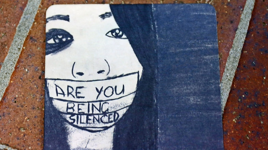 'Are you being silenced' message taped across sketch of a woman
