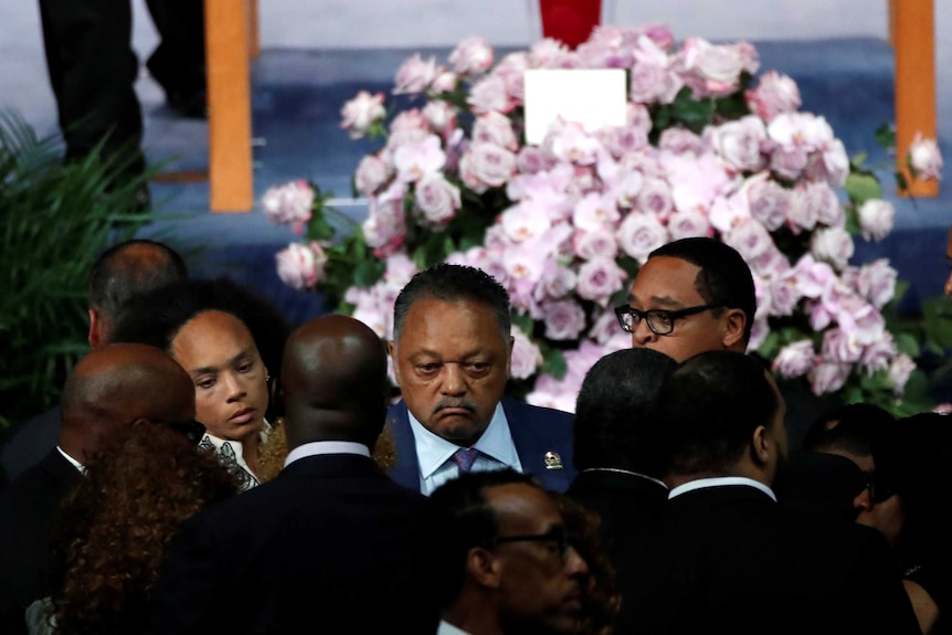 Rev. Jesse Jackson stands with family members after the casket of Aretha Franklin was closed.