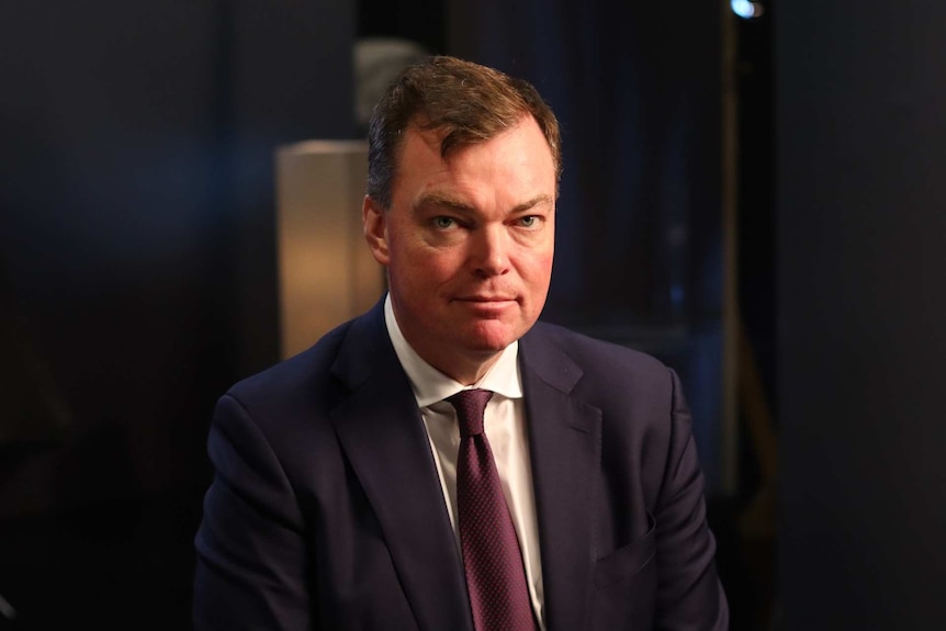 A portrait of Edward O'Donohue looking serious, dressed in a suit and tie.